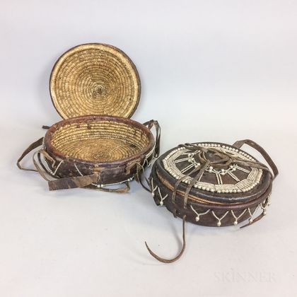 Two Modern Ethiopian Beaded Hide Lidded Baskets. Estimate $200-300