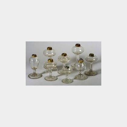 Eight Small Colorless Blown Glass Fluid Lamps