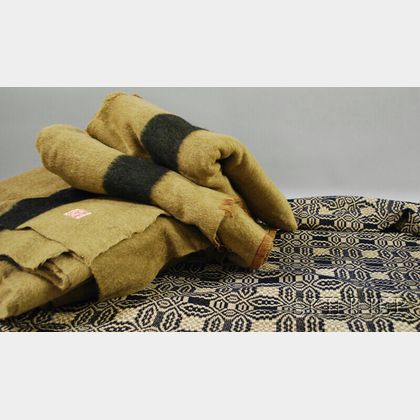 Three Olive Green and Black Hudson Bay Wool Point Blankets and a Blue and White Jacquard Coverlet
