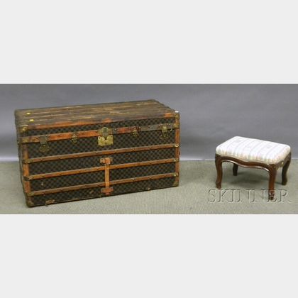 Victorian Rococo Revival Upholstered Carved Walnut Footstool and a Wood, Brass, and Leather-bound Painted Canvas-clad Steamer Trunk