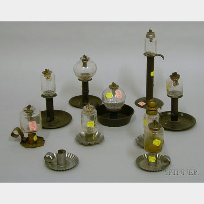 Nine Colorless Glass Peg Lamps on Metal Candlestick Bases. 