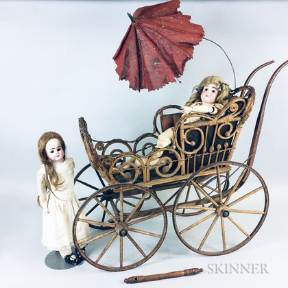 Two German Bisque Dolls and a Victorian Wicker Carriage