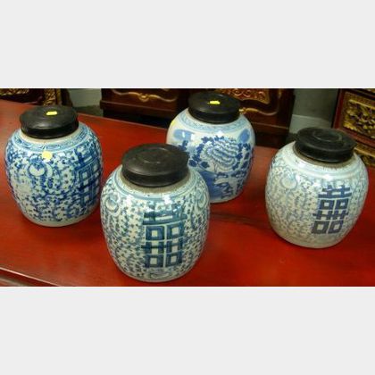 Four Chinese Blue and White Decorated Porcelain Jars with Wood Covers. 