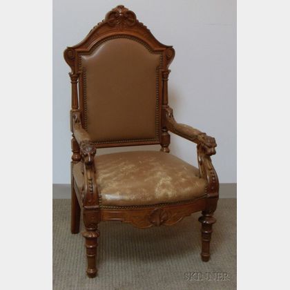 Victorian Renaissance Revival Leather Upholstered Carved Walnut Armchair. 