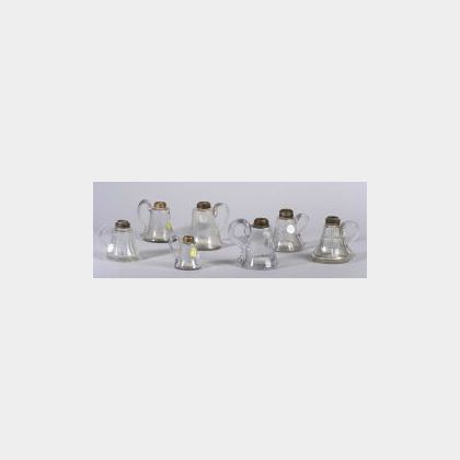 Seven Assorted Colorless Blown Molded Hand Lamps