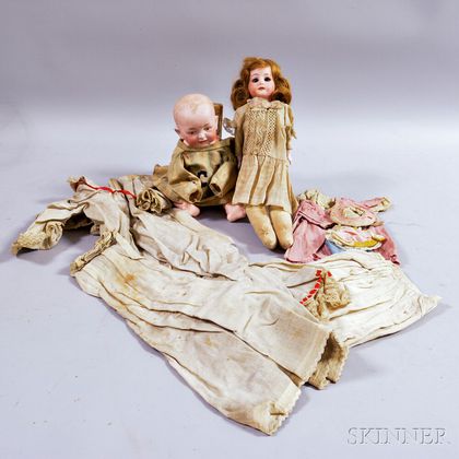 Two Bisque Dolls with Clothes. Estimate $400-600