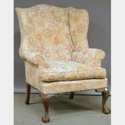 Chippendale-style Upholstered Carved Mahogany Wing Chair with Claw-and-ball Feet. 