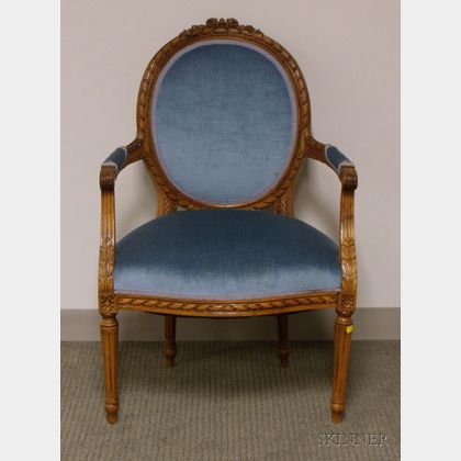 Louis XVI Style Upholstered Carved Walnut Fauteuil. 