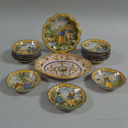 Fourteen Faience Platters and Saucers with Figural Scenes