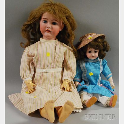 Two German Bisque Socket Head Dolls with Clothes