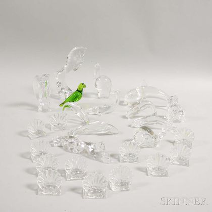 Twenty-five Baccarat Colorless Glass Animals and Place Card Holders. Estimate $400-600