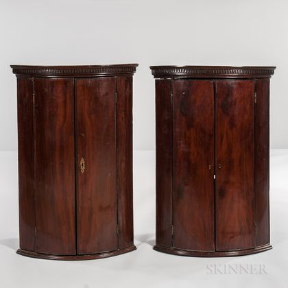 Pair of George III Mahogany and Mahogany-veneered Hanging Bow-front Corner Cabinets