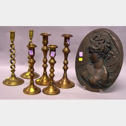 Three Pairs of Brass Candlesticks and a Cast Iron Portrait Plaque. 