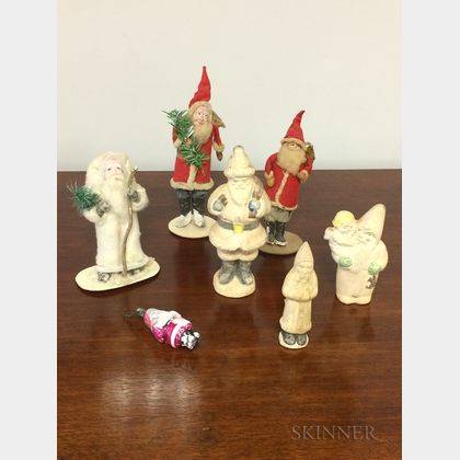 Seven Chalkware, Felt, and Glass Santas