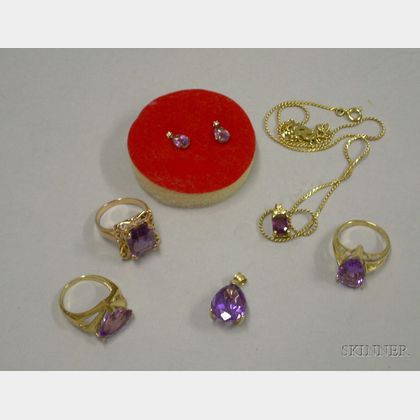 Three Gold and Amethyst Rings, a Pair of Amethyst and Gold Earrings, and a Amethyst and Gold Pendant