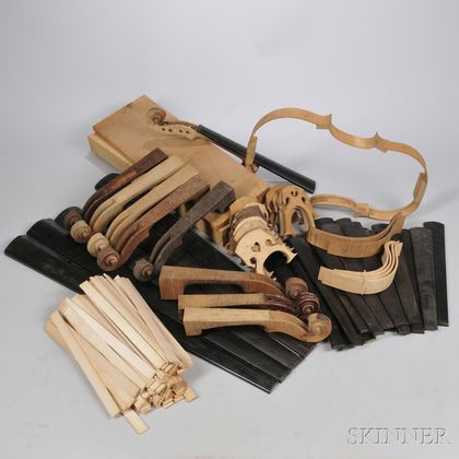 Two Boxes of Violin Wood, Bridges, Scrolls, Ribwood, and Fingerboards. Estimate $100-200