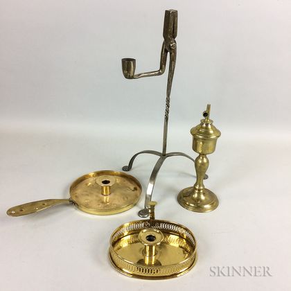 Two Brass Chambersticks, an Oil Lamp, and a Rush Light