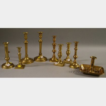 Eight Brass Candlesticks and a Chamberstick