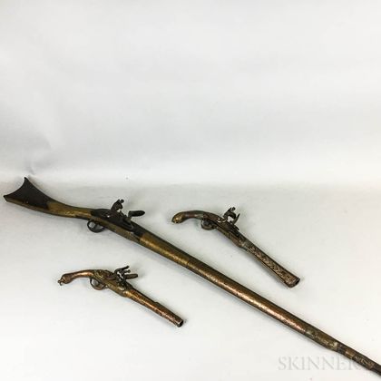 Middle Eastern Brass-clad and Inlaid Musket and Two Pistols. Estimate $150-250