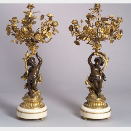 Pair of Louis XVI-style Parcel Gilt Bronze Figural Eight Light Candelabra