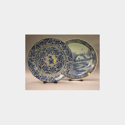 Two Delft Blue and White Earthenware Chargers. comprising one of a landscape scene of a cottage with children skating on a river, signe