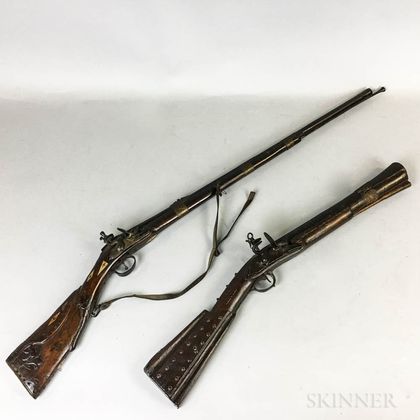 Two Middle Eastern Carved and Brass-clad Muskets. Estimate $100-150