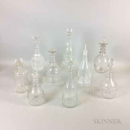 Nine Colorless Cut and Etched Glass Decanters
