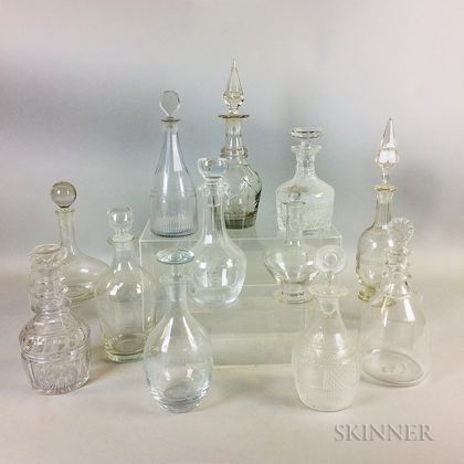 Twelve Cut and Etched Colorless Glass Decanters