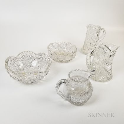 Three Brilliant-cut Colorless Glass Pitchers and Two Bowls. Estimate $20-200