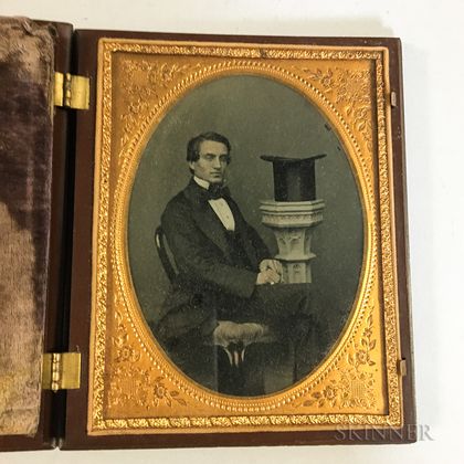 Half Plate Ambrotype Portrait of a Gentleman with a Top Hat in a Union Case. Estimate $200-250