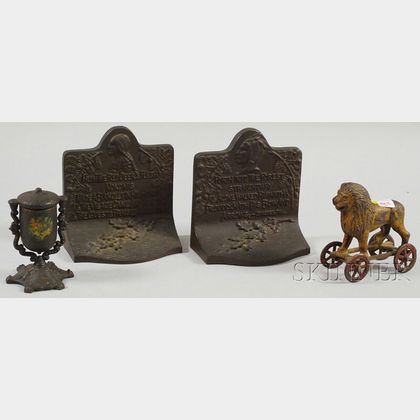 Cast Iron Lion Still Bank Pull-toy, an Acorn-form Matchsafe, and a Pair of Hiawatha Bookends. 