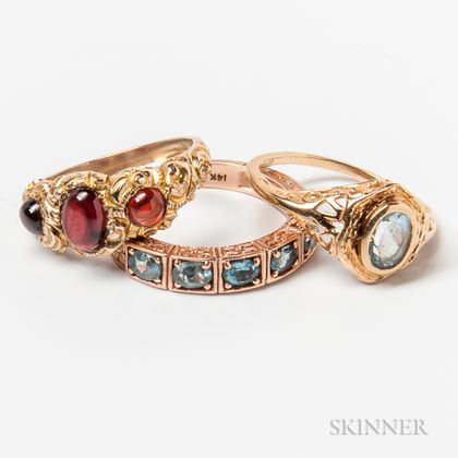 Two 14kt Gold and Aquamarine Rings and a 10kt Gold and Garnet Cabochon Ring