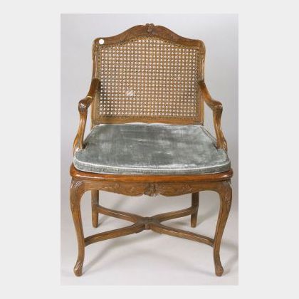 Regence-style Carved Beechwood and Caned Open Armchair