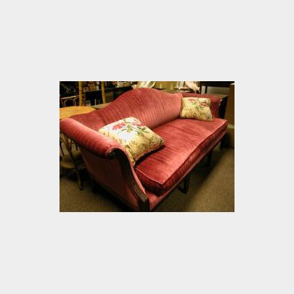 Regency-style Upholstered Camel-back Carved Mahogany Sofa. 