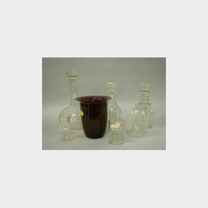 Three Colorless Glass Decanters, Small Glass Whiskey Flask with Tree, a Ruby Glass Vase and Two Glasses. 