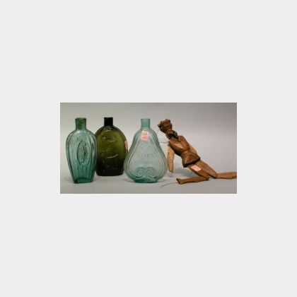 Success to the Railroad Olive Glass Flask, Two Green and Aqua Glass Flasks, and a Reticulated Carved Wooden Figure. 