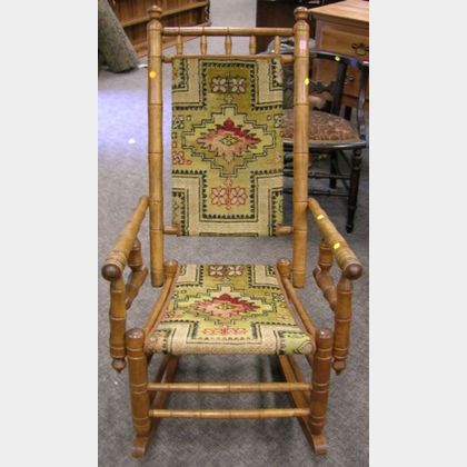 Hunzinger-type Late Victorian Carpet Upholstered Bamboo-turned Maple Armrocker. 