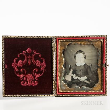 Sixth-plate Tinted Daguerreotype of a Seated Boy Holding a Hatchet