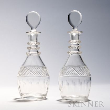 Pair of English Colorless Cut Glass Decanters, 19th century, each bulbous with collared neck and disk-shaped stoppers, ht. 10 1/2 in. 