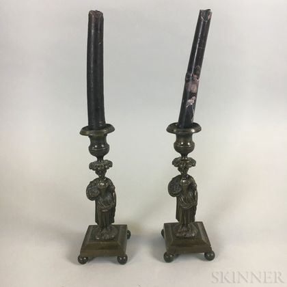Pair of Weighted Bronze Figural Candlesticks