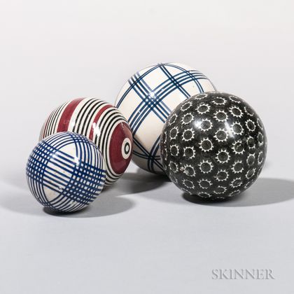 Four Glazed Ceramic Carpet Balls