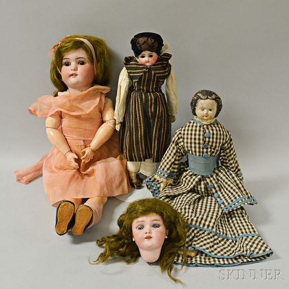 Three Bisque and Composition Dolls, a Bisque Doll Head, and a Trunk of Doll Clothing. Estimate $200-300