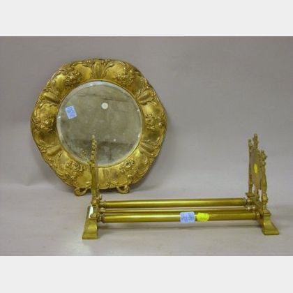 Renaissance Revival Brass Adjustable Book Rack and an Art Nouveau Round Gilt-metal Wall Mirror. 