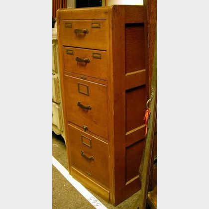 Remington Rand Oak Four-Drawer File Cabinet. 