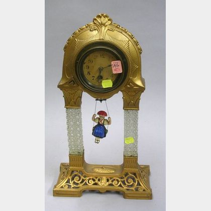 German Gilt Cast Metal and Glass Bouncing Doll Novelty Clock. 