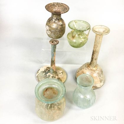 Six Early Glass Vessels. Estimate $300-400