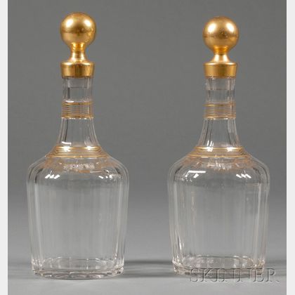 Pair of Colorless and Parcel Gilt Glass Decanters