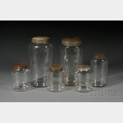 Six Colorless Blown Glass Covered Storage Jars