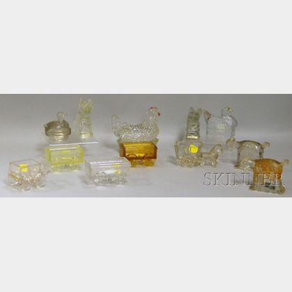 Twelve Mostly Colorless Pressed Glass Figural Candy Containers and Dishes