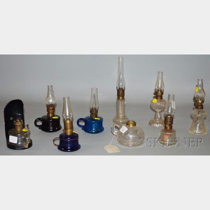 Nine Small Pressed Glass Oil Lamps